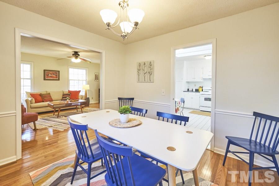 5908 Newhall Road Durham, NC 27713 - Photo 3 of 23 a view of a dining room with furniture and wooden floor