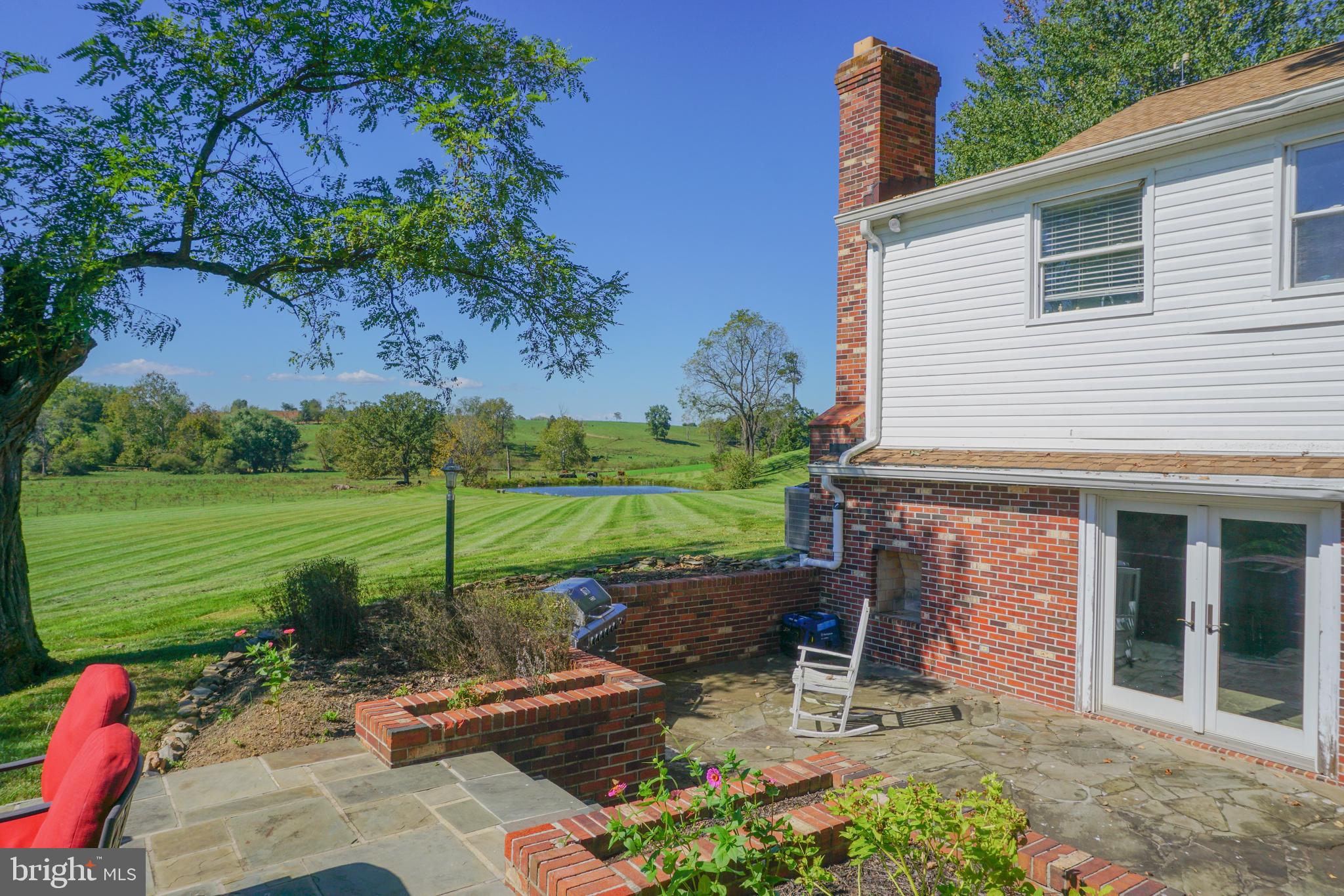 4205 Sams Creek Road New Windsor, MD 21776 - Photo 22 of 103 a view of a chair and table in backyard of the house