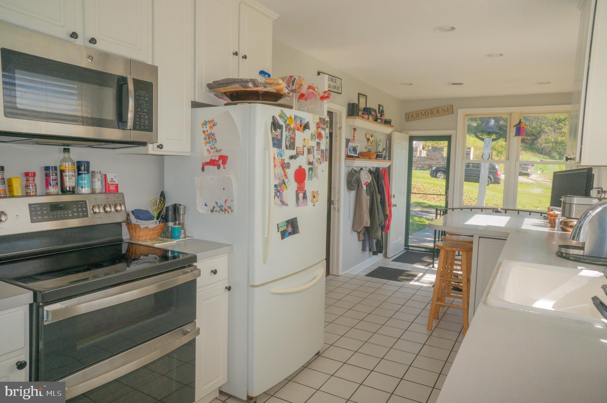 4205 Sams Creek Road New Windsor, MD 21776 - Photo 38 of 103 a kitchen with stainless steel appliances a refrigerator and a stove top oven