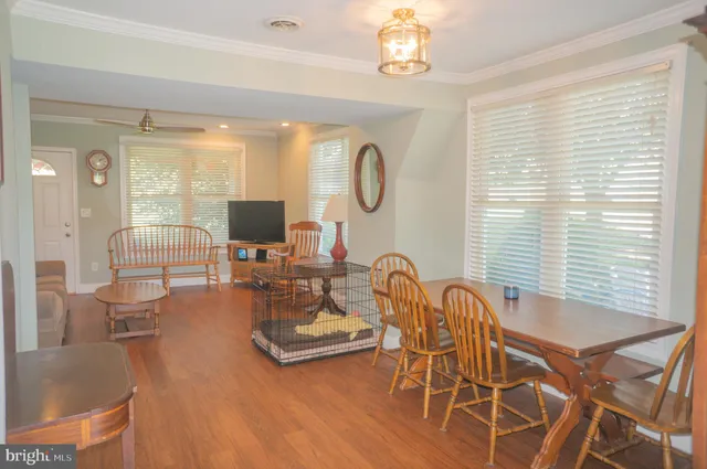 a view of a grassy field with trees in the background