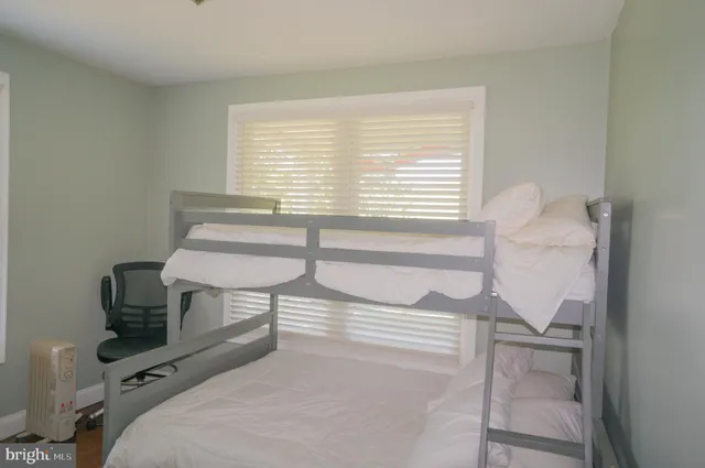 a view of a field with grass and a building in the background