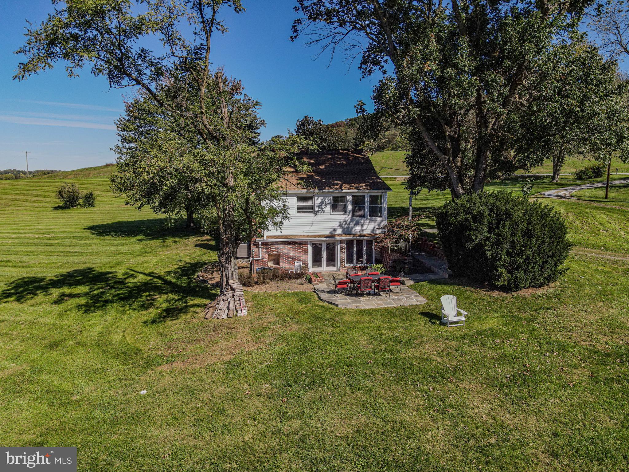 4205 Sams Creek Road New Windsor, MD 21776 - Photo 5 of 103 a view of a swimming pool with lawn chairs and a big yard