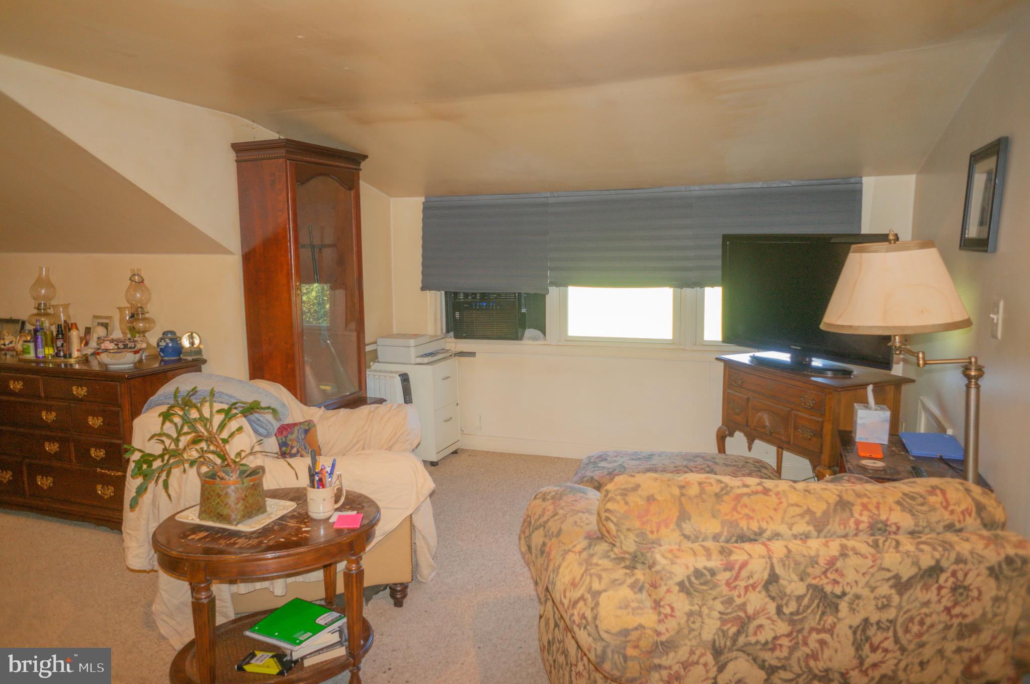 4205 Sams Creek Road New Windsor, MD 21776 - Photo 53 of 103 a bedroom with a bed and a chandelier