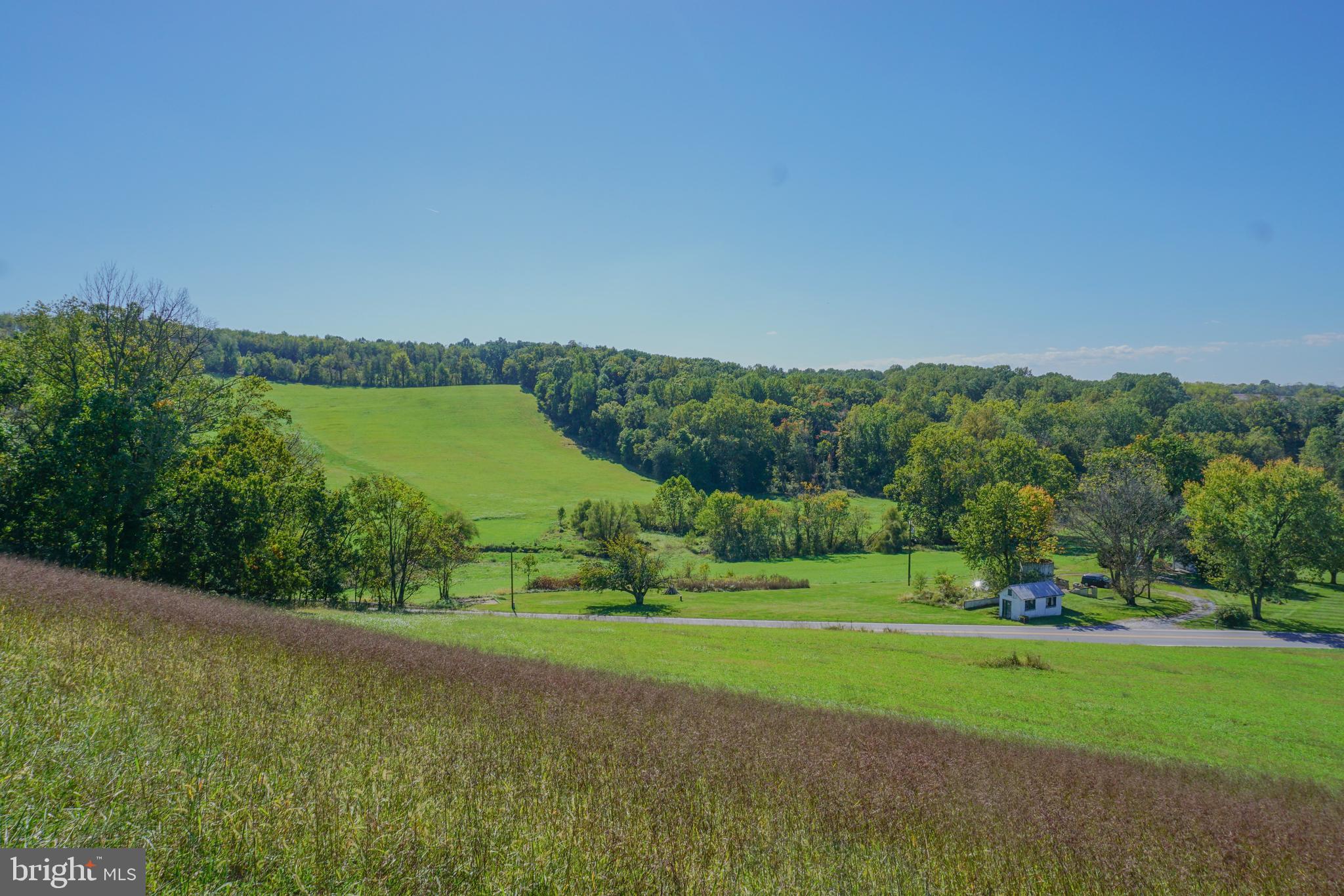 4205 Sams Creek Road New Windsor, MD 21776 - Photo 92 of 103 a view of a golf course with a lake