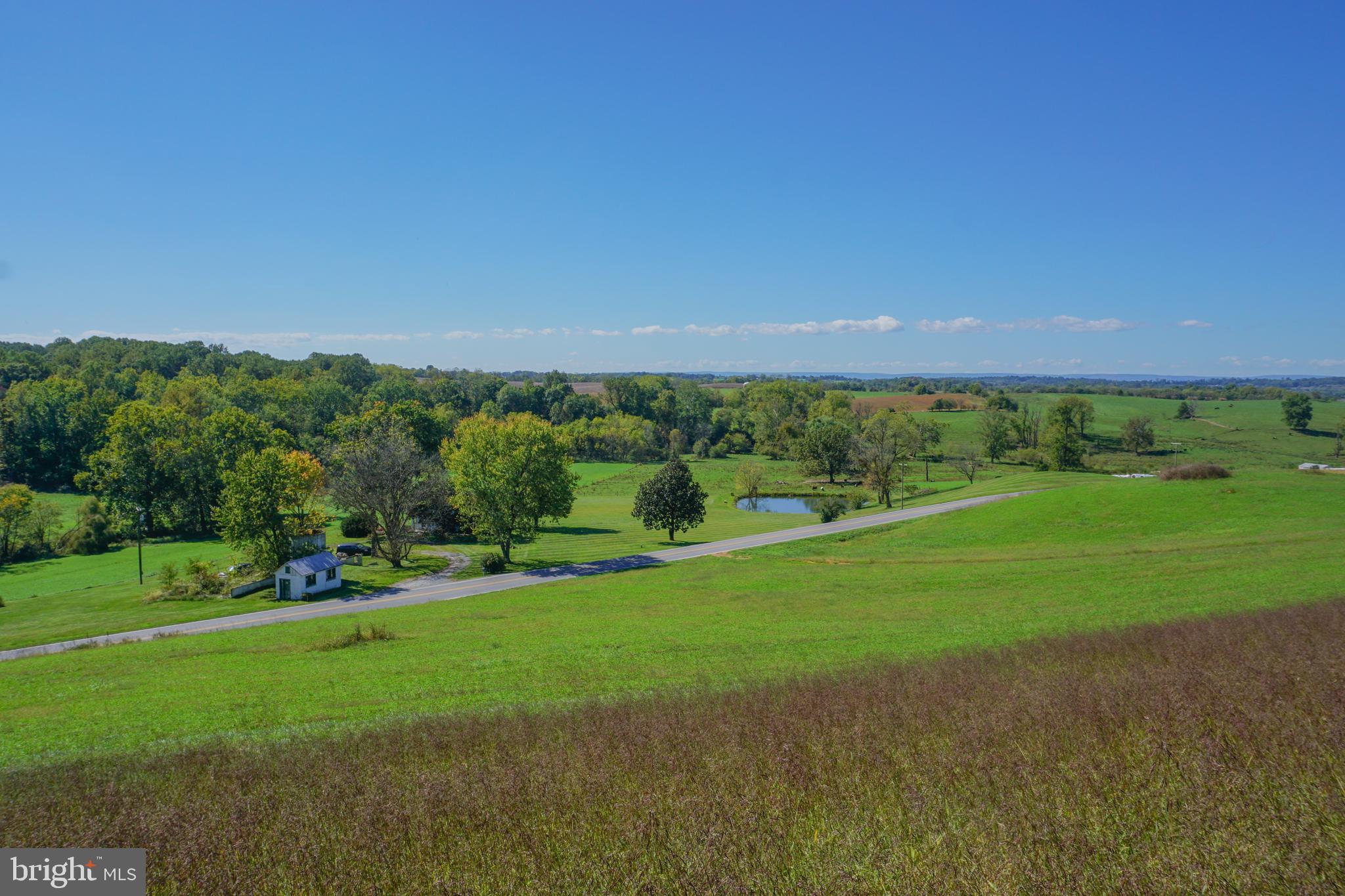 4205 Sams Creek Road New Windsor, MD 21776 - Photo 93 of 103 a view of a field with grass and a building in the background