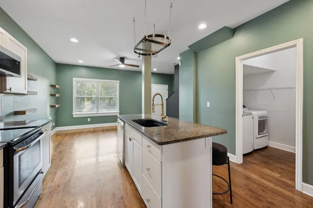 a kitchen with a stove a sink and a refrigerator