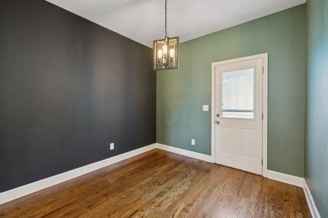 a view of a room with wooden floor closet and windows