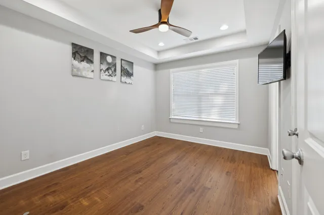 wooden floor in an empty room with a window