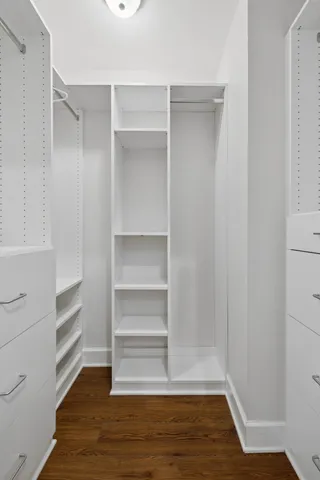 a view of walk in closet with empty racks