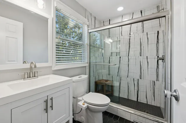 a bathroom with a sink toilet and shower