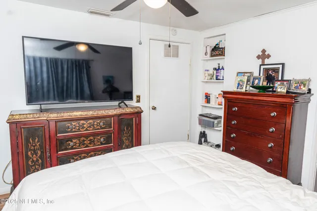 a bedroom with a bed and a dresser