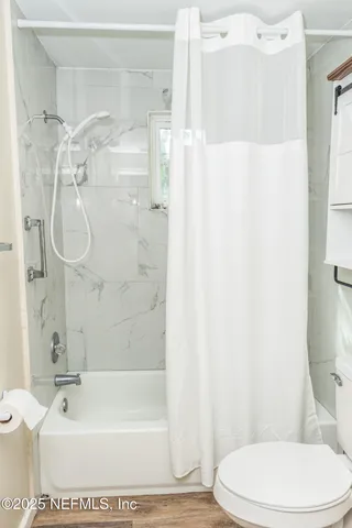 a bathroom with a toilet and shower