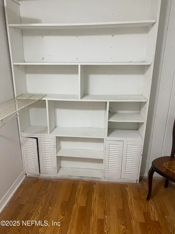 a view of a room with wooden floor and natural light
