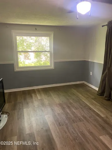 a view of a room with wooden floor