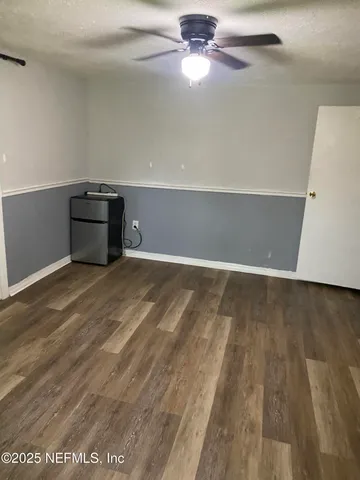 a view of a house with backyard and a tree