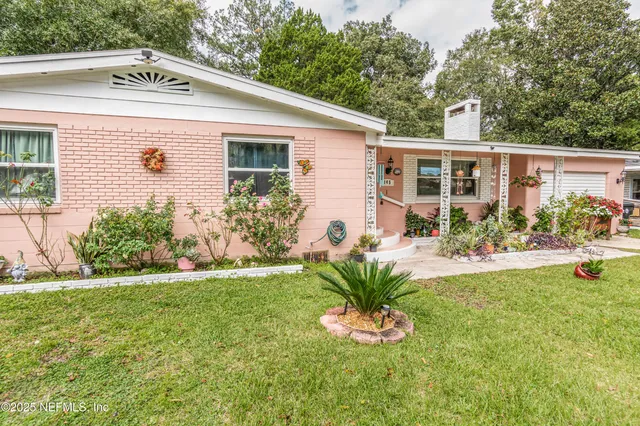 a view of a house with swimming pool and a garden
