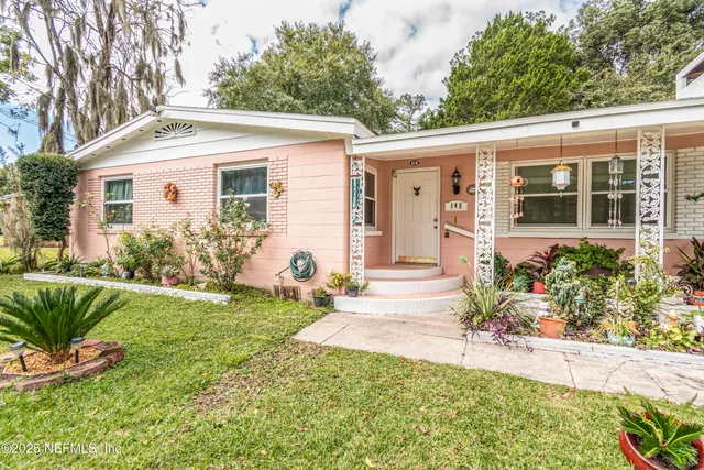 a front view of a house with garden