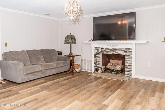 a living room with furniture a flat screen tv and a fireplace