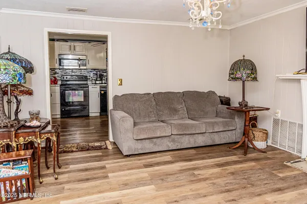 a living room with furniture and a chandelier