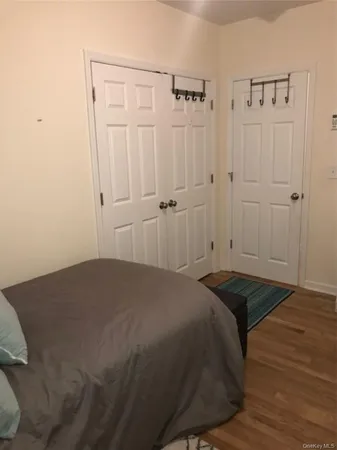 a bedroom with a bed and cabinets