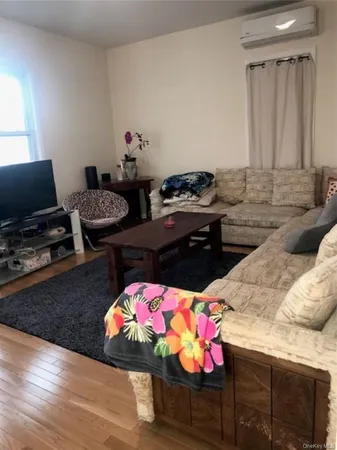 a living room with furniture and flat screen tv