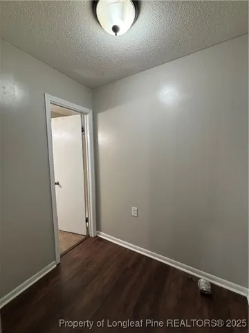 an empty room with wooden floor and window