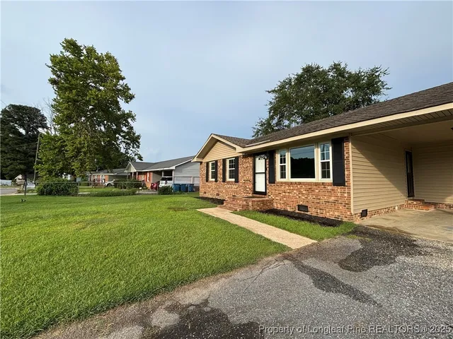 a front view of a house with a garden