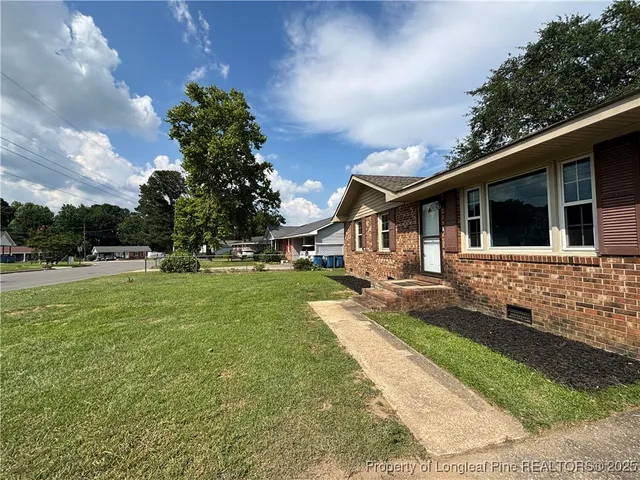 a front view of a house with a yard