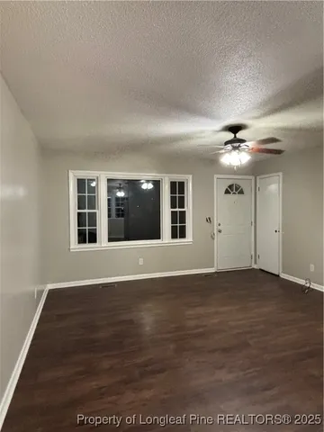 a view of livingroom with hardwood floor and ceiling fan