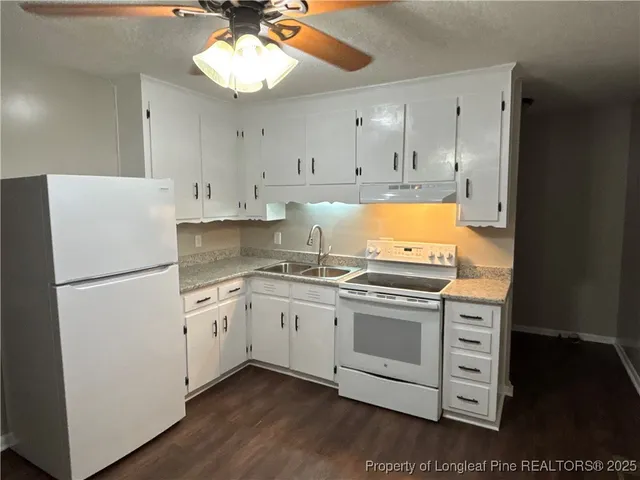 a kitchen with granite countertop cabinets stainless steel appliances and a counter space