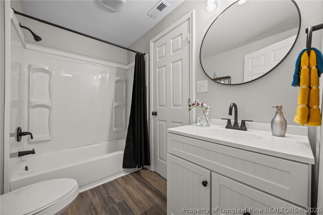 625 Eva Circle Spring Lake, NC 28390 - Photo 20 of 28 a bathroom with a sink a toilet and a mirror