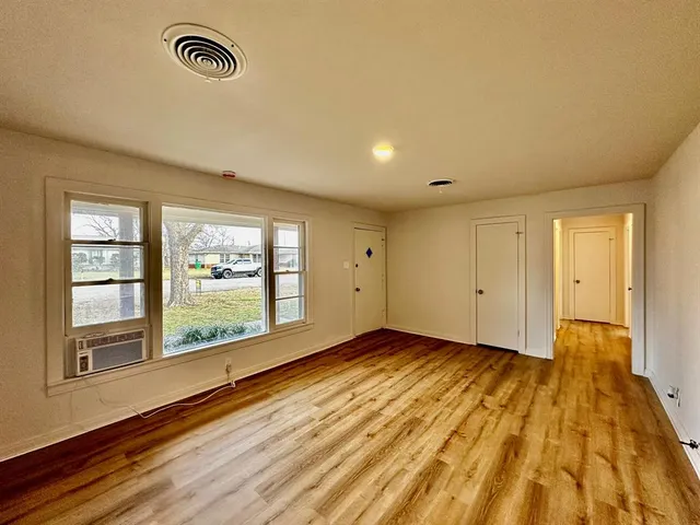 a view of an empty room and a window