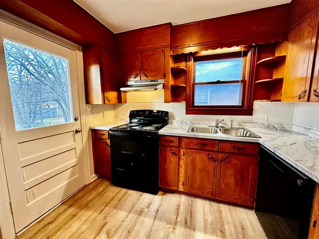 a kitchen with stainless steel appliances granite countertop a stove and a sink