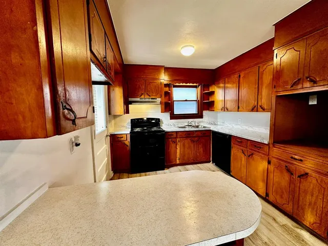 a kitchen with stainless steel appliances granite countertop a stove a sink dishwasher and a refrigerator