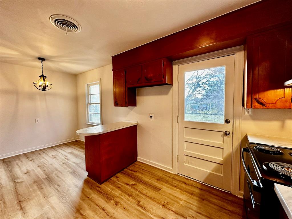 1103 Fair Avenue Gainesville, TX 76240 - Photo 6 of 19 a view of kitchen with wooden floor and electronic appliances
