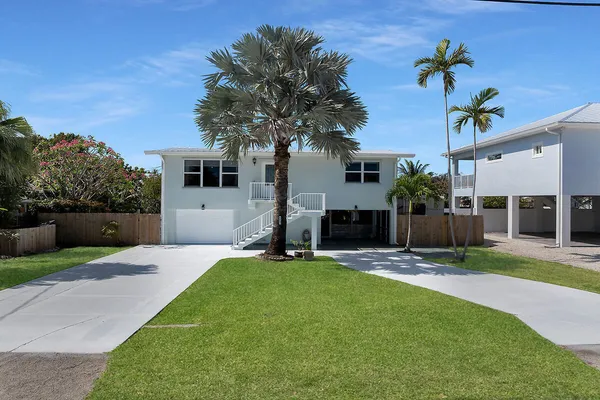 a front view of a house with a yard and porch