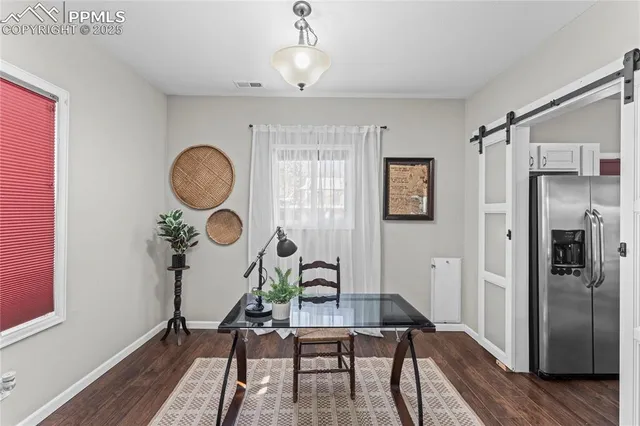 a workspace with wooden floor and a chandelier