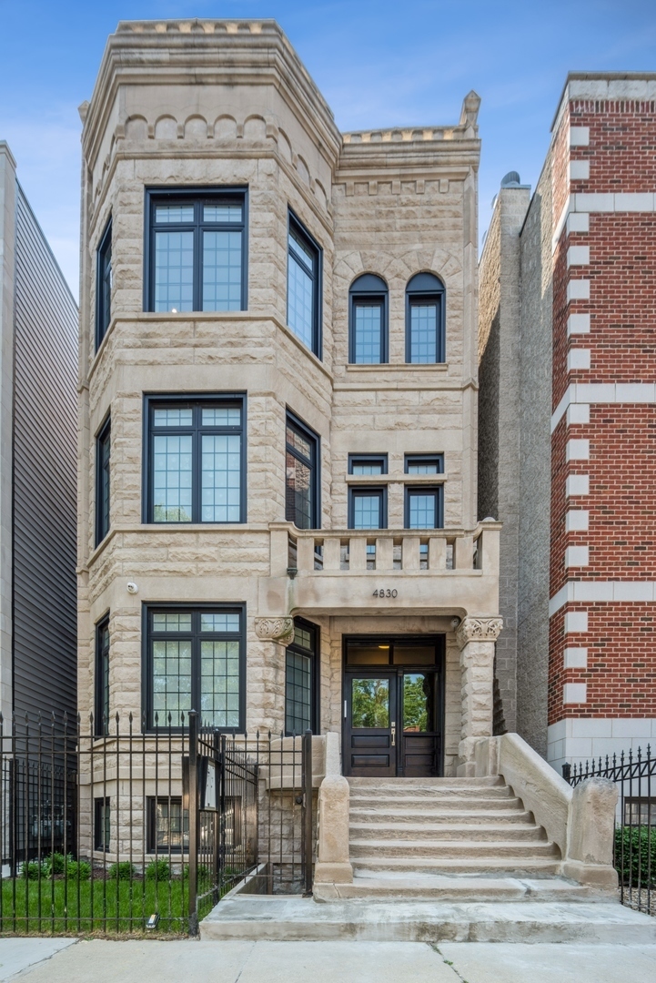 4830 South St Lawrence Avenue, Unit 1 Chicago, IL 60615 - Photo 1 of 10 a front view of a house with a yard