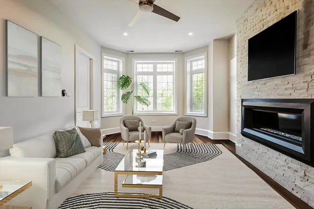 a living room with furniture a flat screen tv and a fireplace