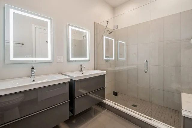 a bathroom with a shower sink and mirror