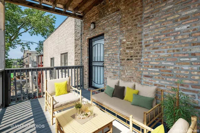 a view of a deck with couches with wooden floor and fence