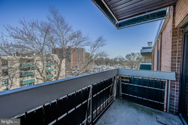 a view of balcony with wooden floor and fence