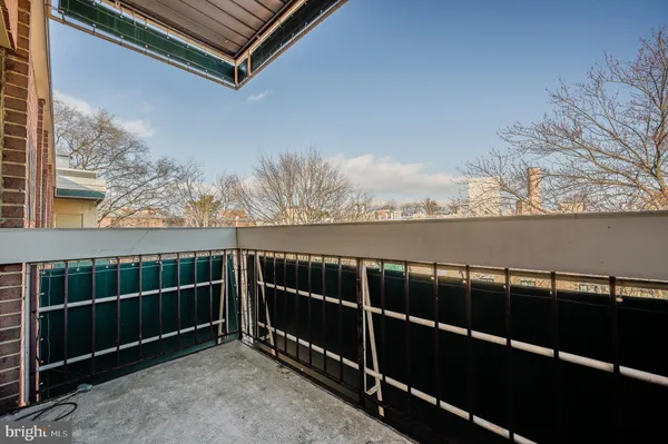 a view of a roof deck with wooden fence