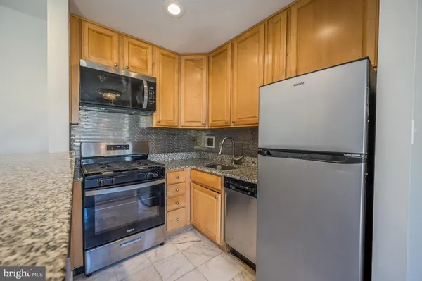 a kitchen with a sink stove and microwave