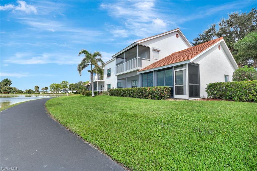 613 Windsor Square, Unit 101 Naples, FL 34104 - Photo 17 of 22 a front view of a house with garden