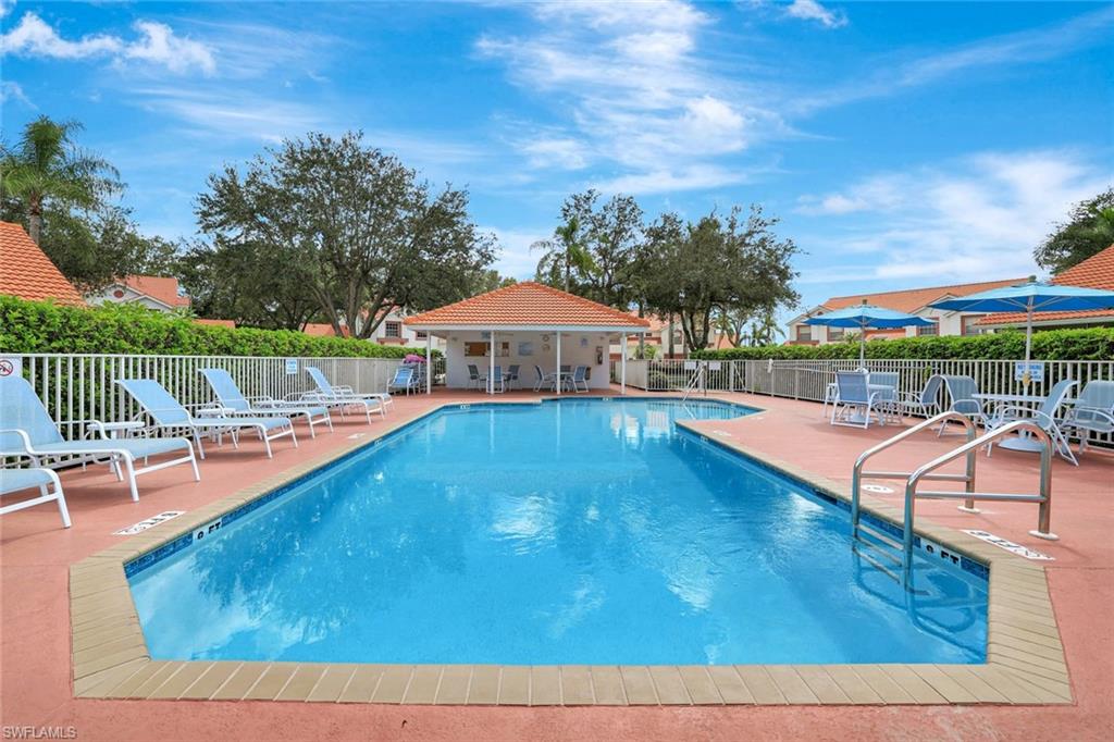 613 Windsor Square, Unit 101 Naples, FL 34104 - Photo 19 of 22 an outdoor space with pool and furniture