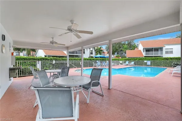 a view of a patio with a dining table and chairs