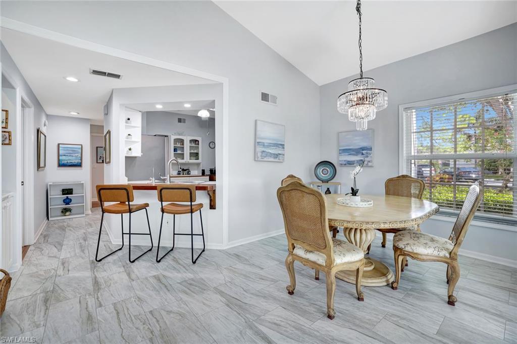 613 Windsor Square, Unit 101 Naples, FL 34104 - Photo 3 of 22 a view of a dining room with furniture window and wooden floor