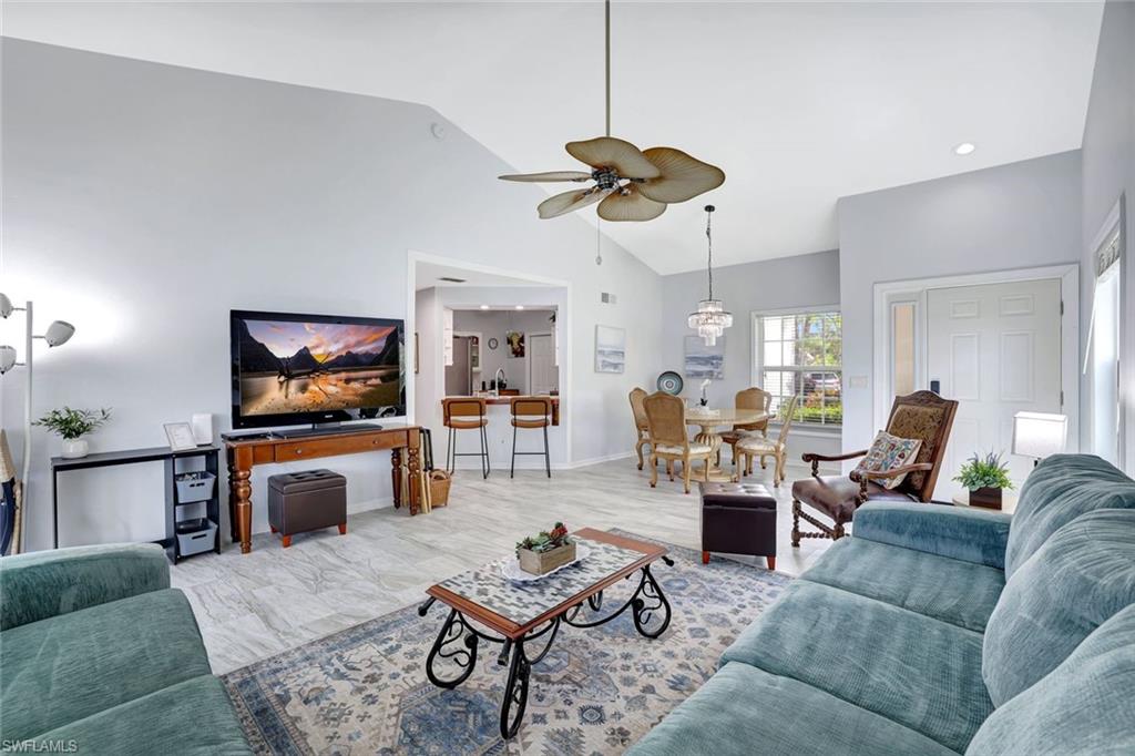 613 Windsor Square, Unit 101 Naples, FL 34104 - Photo 7 of 22 a living room with furniture and a flat screen tv