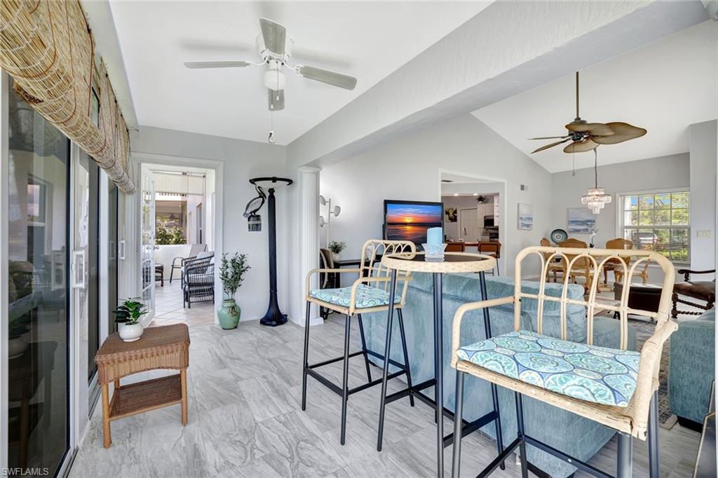 613 Windsor Square, Unit 101 Naples, FL 34104 - Photo 9 of 22 a work room with furniture and a chandelier